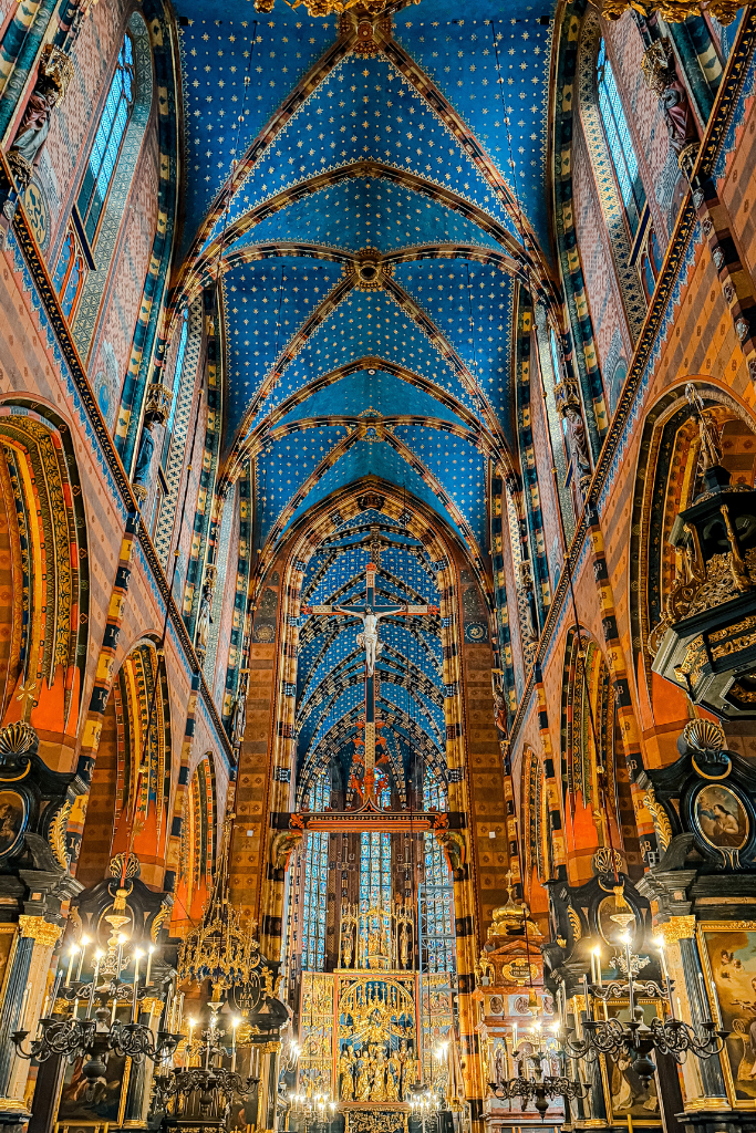 Ornate interior of St. Mary’s Basilica in Krakow with its famous blue star-covered ceiling and Gothic altar.
