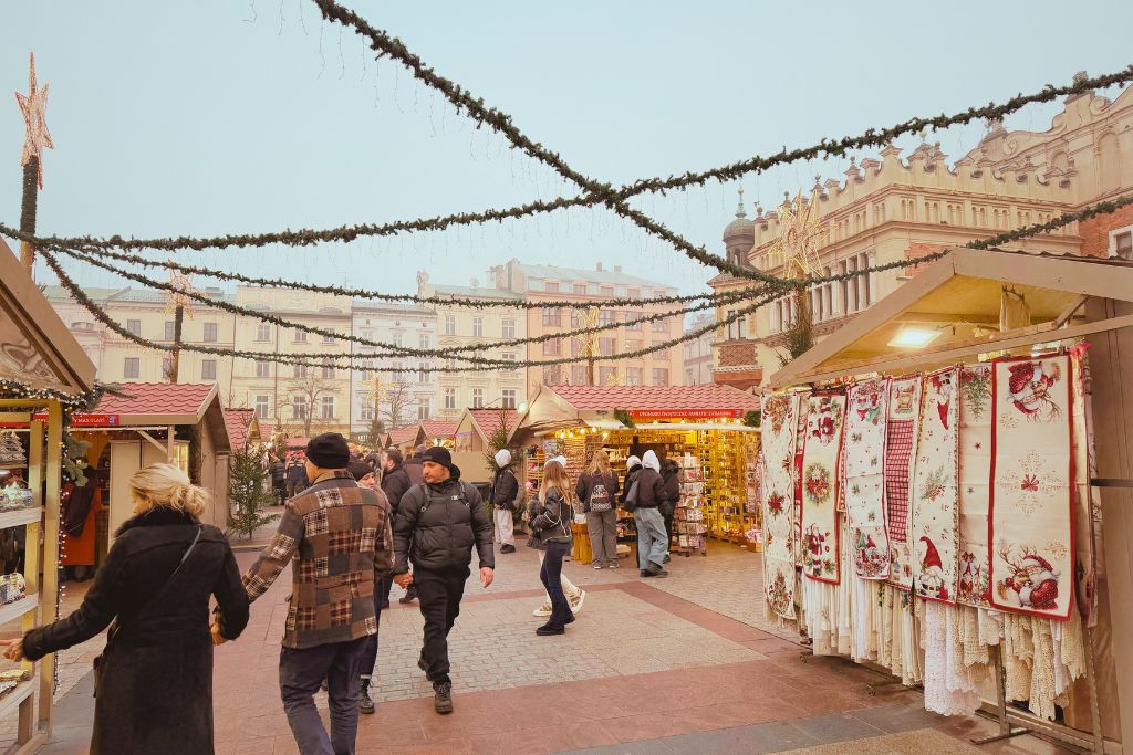 Krakow Christmas Market stalls selling festive gifts and Polish souvenirs in the Main Market Square.