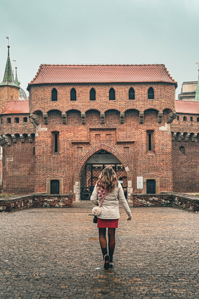 Kate walking toward Krakow’s historic Barbican while exploring the Old Town.