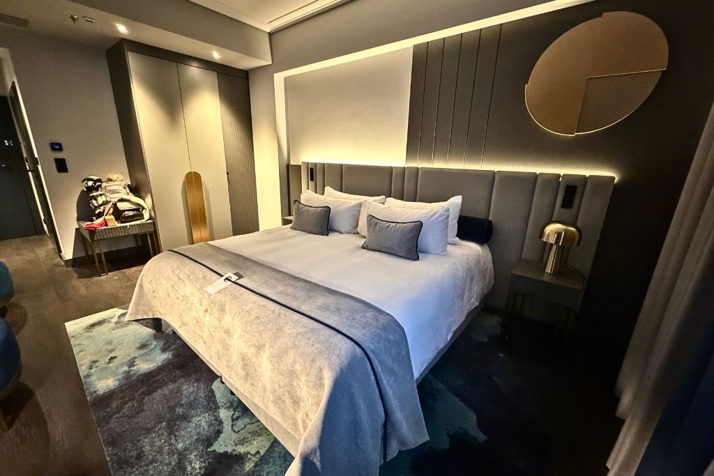 Comfortable king bed and modern decor inside a room at Garamond Hotel in Krakow.