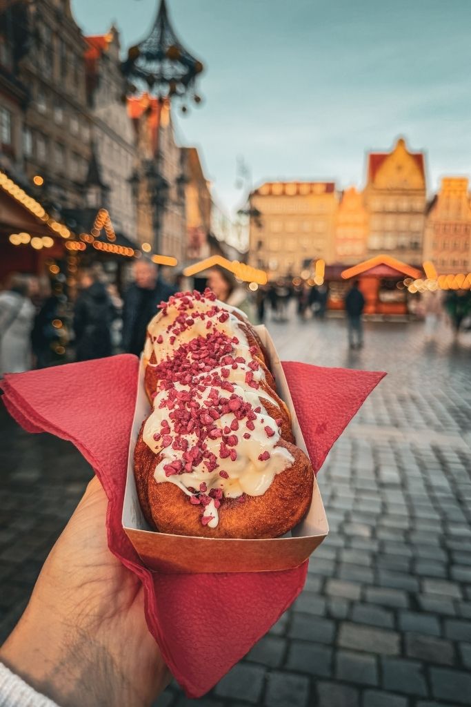 Sweet Christmas market pastry topped with cream and raspberries at the Wroclaw Christmas Market.