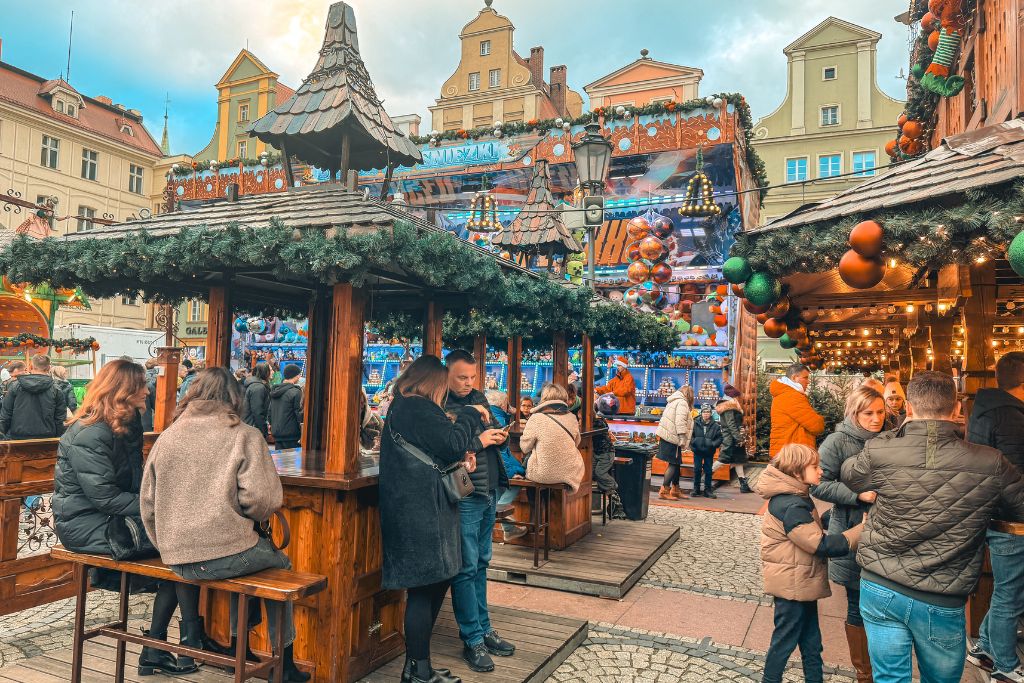 Salt Square Christmas Market in Wroclaw with festive wooden stalls, family attractions, and colorful historic buildings.