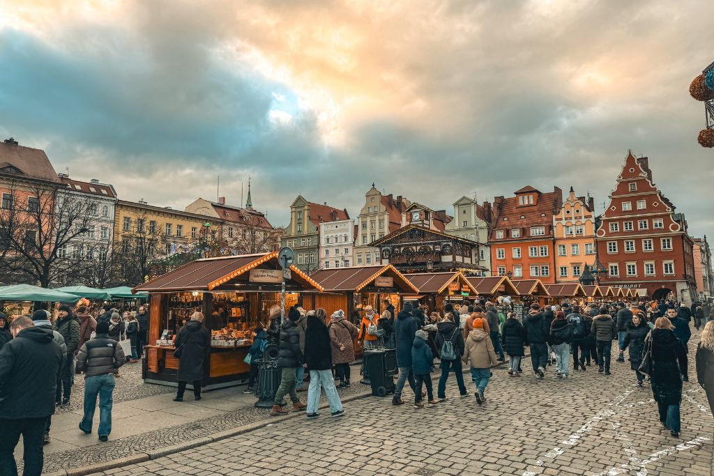Wroclaw Christmas Market filling Salt Square with wooden stalls, holiday lights, and colorful Old Town buildings.