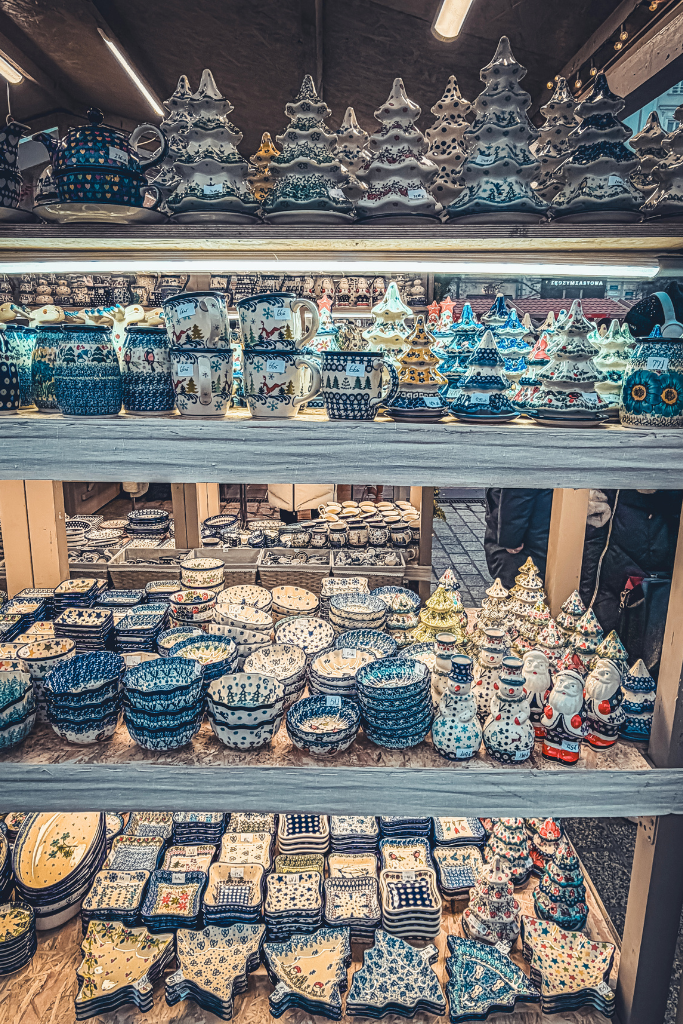 Colorful Polish pottery, Christmas tree decorations, and festive ceramics for sale at Krakow Christmas Market.